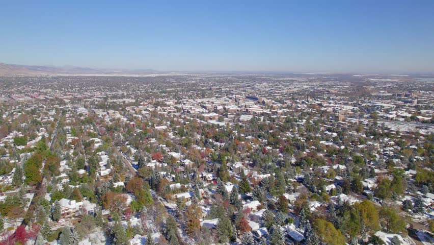 Neighborhood around University of Colorado Boulder on a fall day with snow. Drone Aerial of Boulder, Colorado, USA on a clear day.