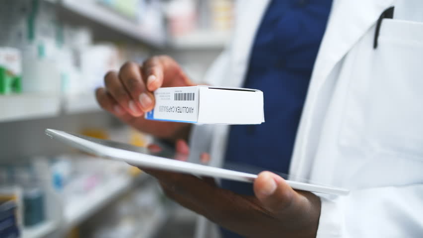 Black man, hands and pharmacist with tablet, box or medication for inventory inspection at store. Closeup of male person or doctor with technology checking pharmaceutical stock or drugs at pharmacy