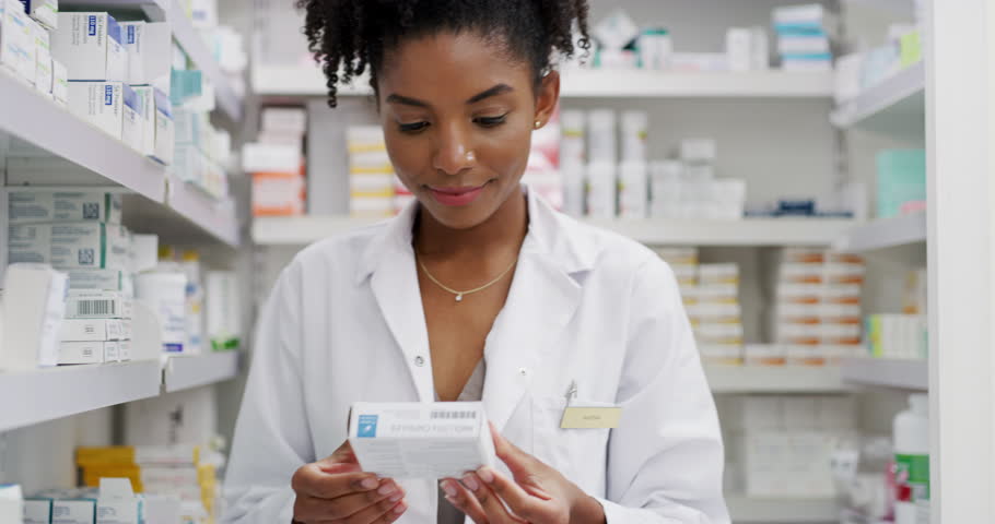 Pharmacist, woman and medicine box for shelf management, reading label and stock research or medical inventory. African doctor with healthcare, clinic product for pharmacy, store pills or drugs check