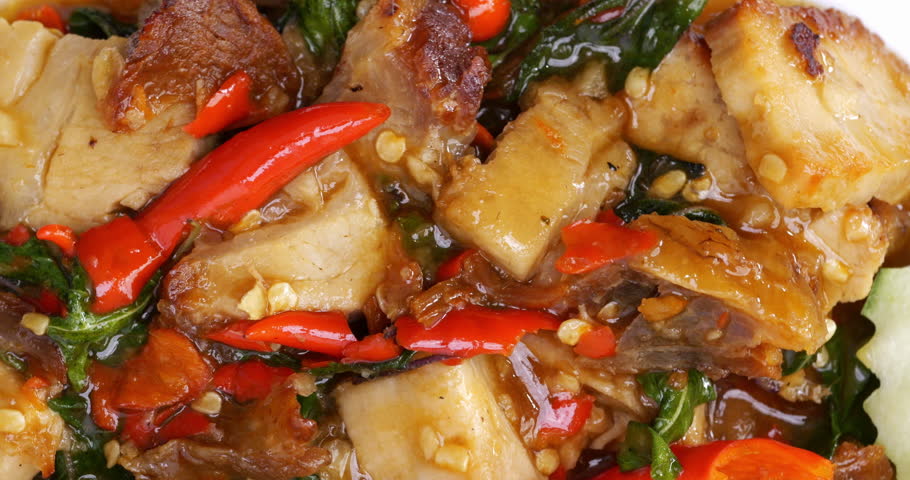4K footage vertical video Rotating Macro shot top view textureCrispy pork with basil over rice, fast street food.