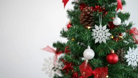 Woman decorating christmas tree with beautiful red and white bow. Girl adorned with holiday ribbon Xmas ornaments. New year decor design element - Powered by Shutterstock - Get 15% off with code: PIKWIZARD15