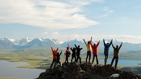 Group of hiker joy with travel success and together raise arms standing on top of high mountain at scenic view. Happy achievement in tourism and summit motivation - Powered by Shutterstock - Get 15% off with code: PIKWIZARD15