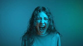Portrait of Young Woman Looking at Camera and Screaming in Neon Color of Bright Studio. Headshot of European Girl Shouting in Aggressive Crisis. Suffering Face of Yelling Person in Intense Brutal Fury - Powered by Shutterstock - Get 15% off with code: PIKWIZARD15