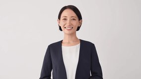 Portrait of  Asian middle aged businesswoman smiling in white background - Powered by Shutterstock - Get 15% off with code: PIKWIZARD15