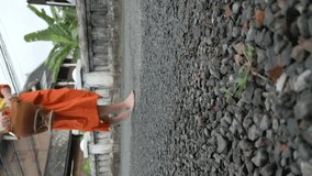 Vertical video. Monks feet close up. Monks strolling through the streets of Luang Prabang during their morning alms collection in Laos. 