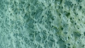 Vertical video, Freshwater spring makes its way through seabed, forming a relief with small sandy hils and craters, Mediterranean Sea, Slow motion. Fresh water source on sand bottom