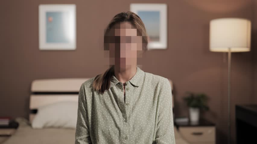 Hidden identity, hidden face, unknown person, silhouette interview. Woman talking to an interlocutor or looking at camera, her face is hidden