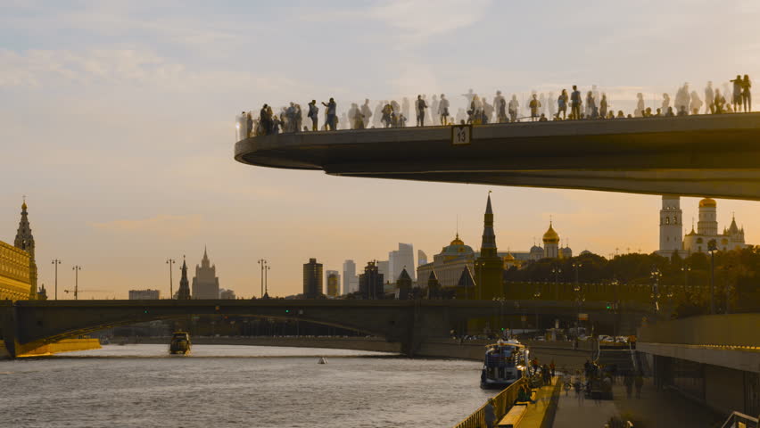 Time lapse, Soaring bridge with people above Moscow river in the park, view at Kremlin, Russia