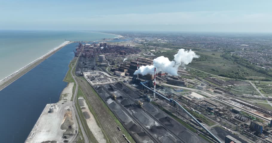 A large iron and steel factory in the town of Groot Sinten Grande Synthe, near Dunkirk, France. It is an integrated iron and steel company with blast furnaces, steel mills and rolling mills covering a | Shutterstock HD Video #1110975683