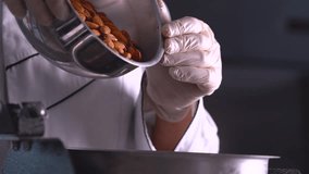 The French pastry chef adds almonds to the grain grinding machine - Powered by Shutterstock - Get 15% off with code: PIKWIZARD15