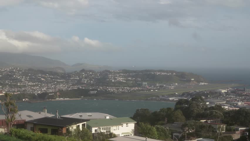 A view of Wellington city in New Zealand near the airport, with the blue ocean and strong winds.