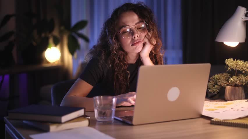 Boring tired young student or freelancer  falling asleep during study or work at home workplace at late night Stressed female exhausted from remote distance work or education and hard program indoors Royalty-Free Stock Footage #1110996629