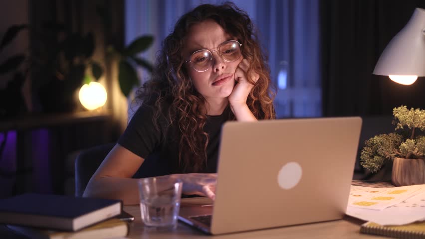 Boring tired young student or freelancer  falling asleep during study or work at home workplace at late night Stressed female exhausted from remote distance work or education and hard program indoors