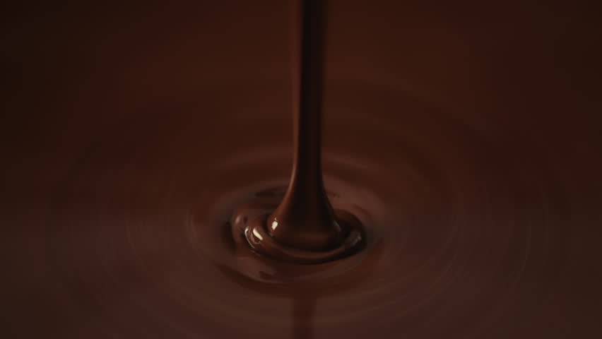Slow motion shot pouring melted chocolate, close-up seamless dripping hot liquid chocolate flows, waves flowing molten chocolate or dark caramel sauce. Chocolate wavy drip. Confectionery cooking Royalty-Free Stock Footage #1110998517