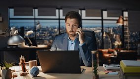 Confident boss calling mobile phone at evening city view office closeup. Focused man talking smartphone listening interlocutor at panoramic windows workplace. Serious businessman working late at night - Powered by Shutterstock - Get 15% off with code: PIKWIZARD15