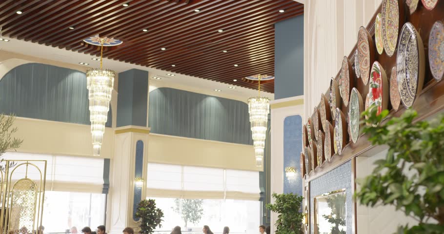 Ceramic plates with ornaments as an element of wall decor in the hotel lobby