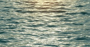 Professional work 4K DCI 4096x2160p. Slow motion video Water wave texture at sunset reflection Golden texture wave background beautiful water wave background High quality footage ProRes422