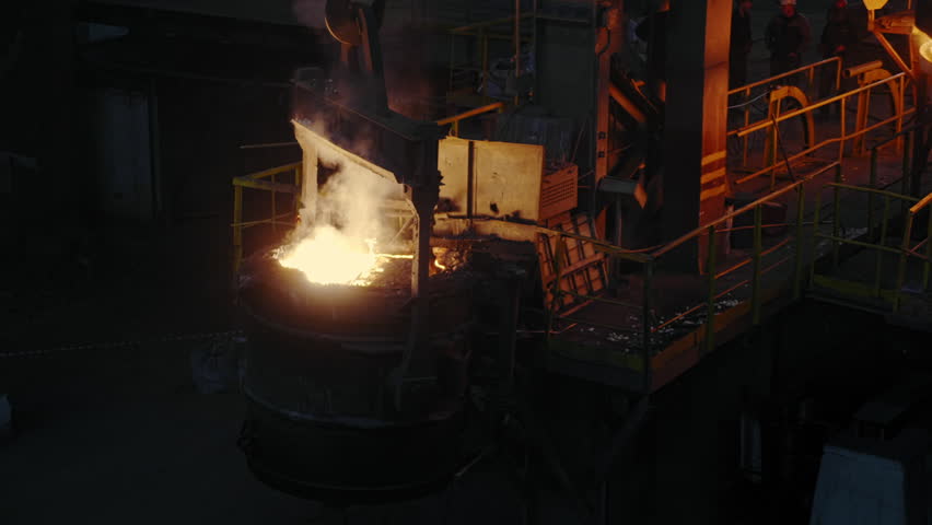 Industrial workshop at the plant. Steel melts into the pool of molten metal in an induction furnace. Foundry Aluminum Cast Manufacture Factory. Heavy industry. Metallurgy. Dark Wide Shot. Slow motion | Shutterstock HD Video #1111024445