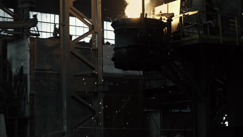 A Huge Container With a Crane is Transporting Hot Liquid Molten Metal. Metal Casting, Foundry, Manufacture, Factory. Industrial Factory. Aluminum Cast. Heavy industry. Wide Shot, Slow Motion | Shutterstock HD Video #1111024451