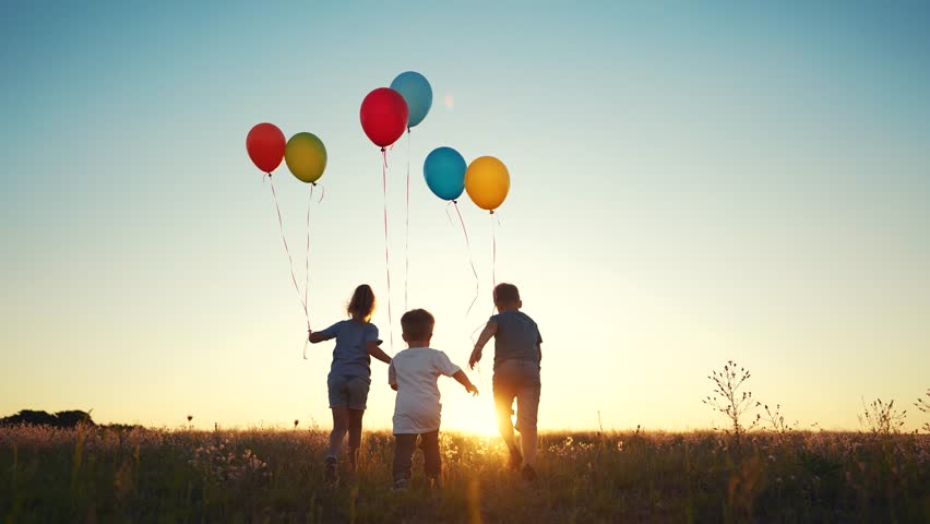 children walk across field. happy family kid dream concept. a group of children are running along road field with colorful balloons. guys running across field with large colored lifestyle balloons Royalty-Free Stock Footage #1111025165