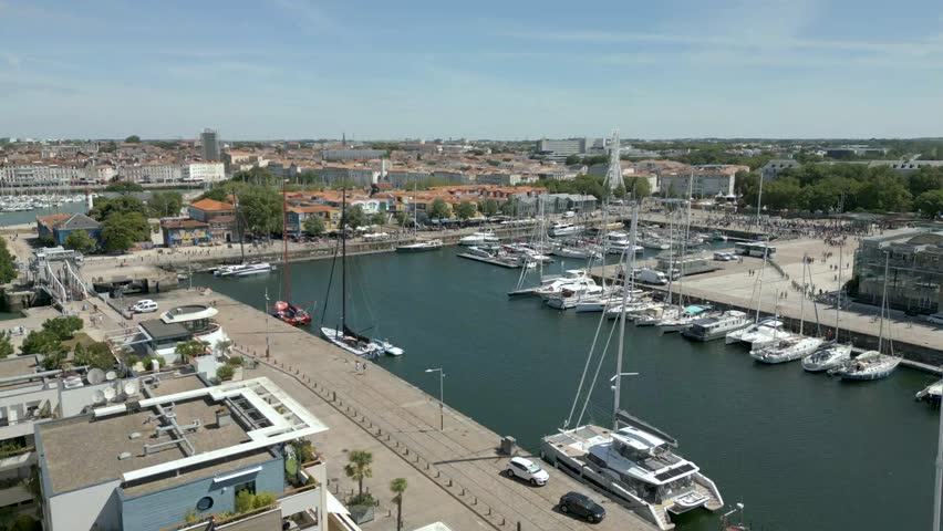 Boats moored in old port of La Rochelle, Charente Maritime in France. Aerial forward and sky for copy space