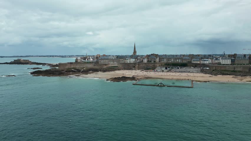 Saltwater pool on beach of Saint-Malo old city, Plage de Bon Secours, France. Aerial drone view and space for copy
