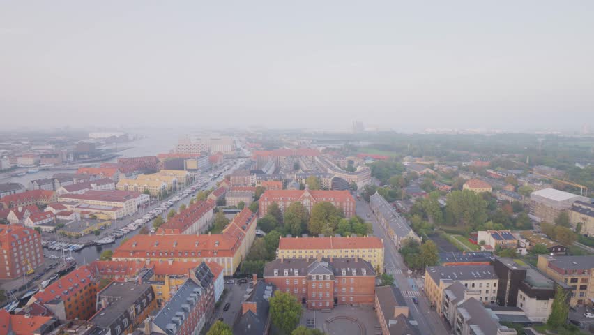 Aerial drone shot of the cityscape of Copenhagen, Denmark during sunset