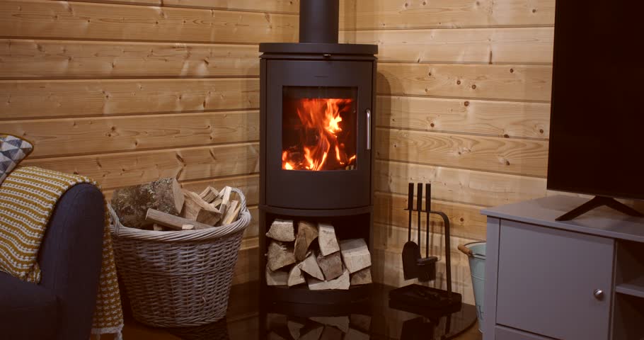 wide shot of a fire in a wood burner with kindling and logs in a log cabin. Royalty-Free Stock Footage #1111029545