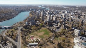 Aerial video of City Park, Saskatoon, SK, revealing its vibrant streets, urban green spaces, and historic architecture. A blend of city life and nature, ideal for urban exploration.