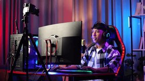 Asian Boy Streamer Screaming Goal And Dancing Celebrating Winning Game Over Network On Personal Computer. Live Stream Video Game, Desk Illuminated By Rgb Led Strip Light