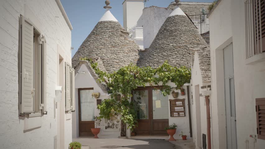 charming italian white trulli house in alberobello with green plants Royalty-Free Stock Footage #1111041903