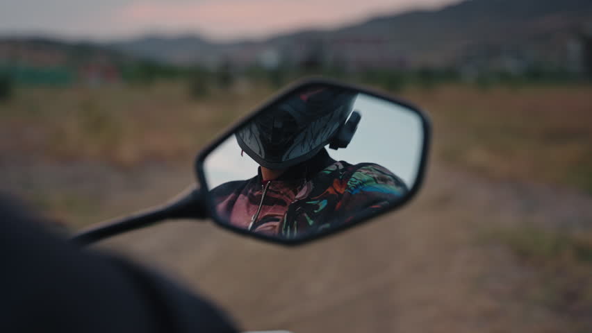close up of a man in looking into the motorcycle