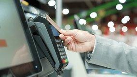 Close up Woman At Counter Buy electronic payment supermarket by credit card close-up. African american female hand pay for purchases in stores Contactless NFC Terminal Closeup card reader - Powered by Shutterstock - Get 15% off with code: PIKWIZARD15