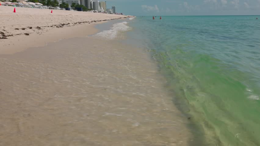 Captivating sight of Atlantic Ocean waves gently rolling onto sandy shores of Miami Beach. USA. | Shutterstock HD Video #1111043687