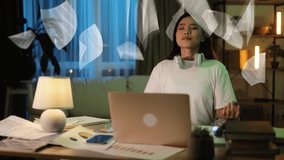 Late-night dedication: A young Asian woman meditate immersed in her work at home, surrounded by floating holographic documents. Inspiring the balance between work and rest - Powered by Shutterstock - Get 15% off with code: PIKWIZARD15
