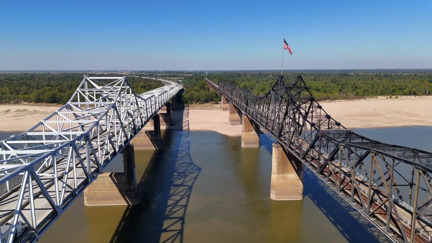 Railroad bridge with American Flag waving over Mississippi River at Vicksburg Mississippi.