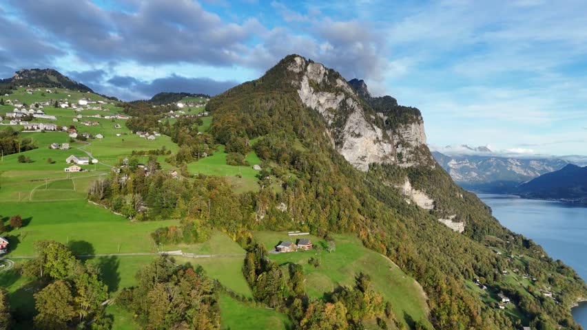 Towering mountains in beautiful alp setting with dramatic cloudscape during sunset. Amden, Switzerland