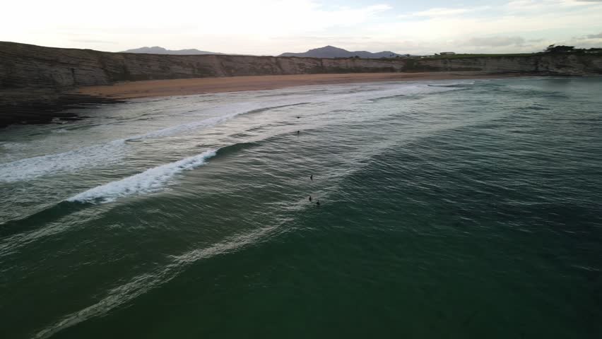 Group of surfers waiting for surfing waves to come at oceancliff shore