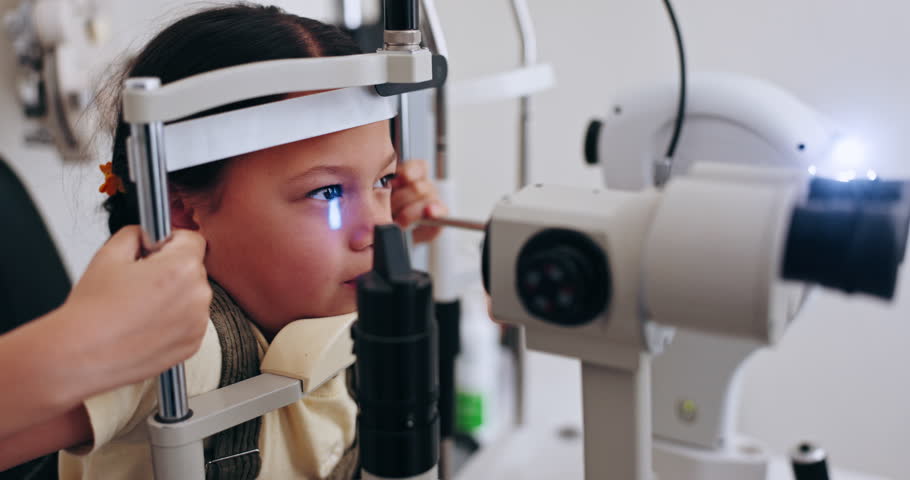 Optician, child and eye test for eyeglasses, vision and smile for eyecare and glasses. Machine, medical and senior doctor for eyesight, optometry office for a visual exam and prescription eyewear Royalty-Free Stock Footage #1111047625