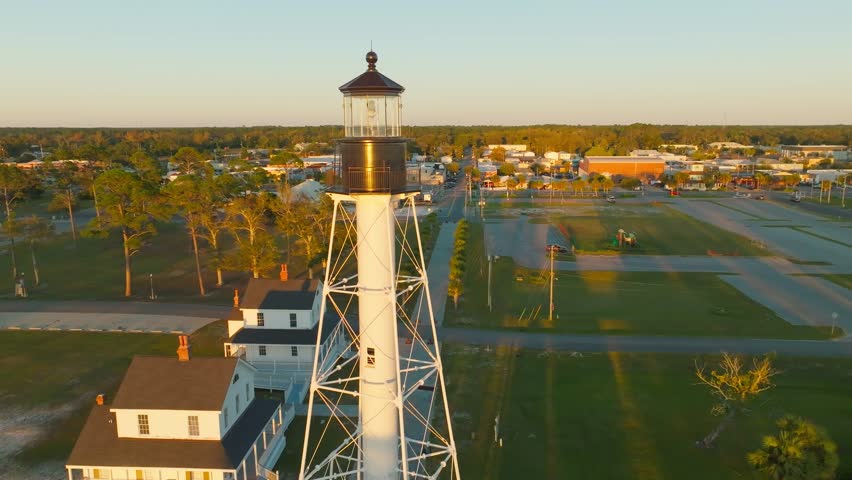 Drone video circling the Cape San Blas Lighthouse in Port St. Joe, Florida during sunset with beautiful water views