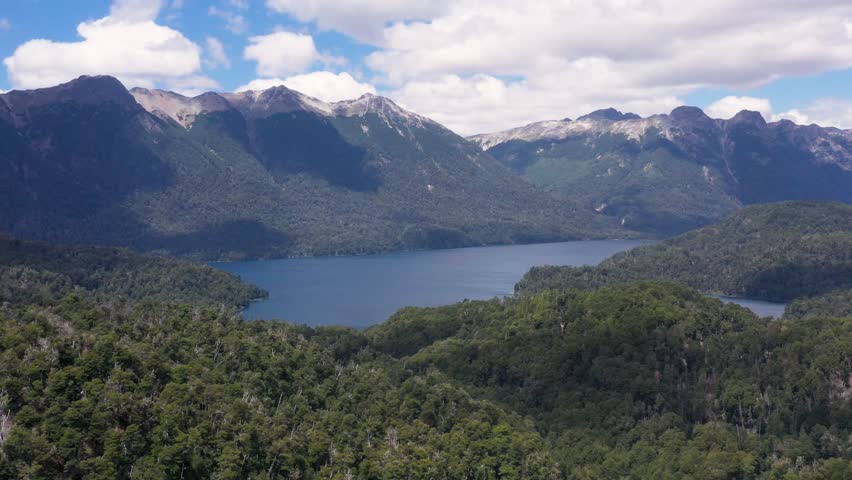 Drone flying over mountains and lakes of the "Ruta de los Siete Lagos"road, that go up the Andes mountains to Bariloche, in Argentina  Royalty-Free Stock Footage #1111051193