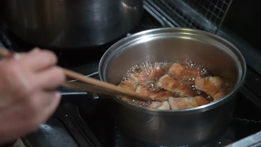 A woman stewing pork belly
 Royalty-Free Stock Footage #1111059327