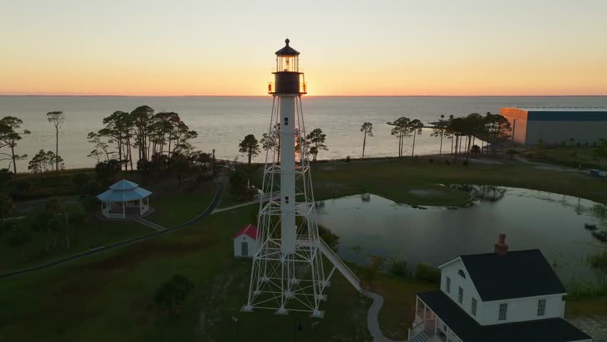 Drone shot of sunset and beautiful coastal views passing by the Cape San Blas Lighthouse in Port St. Joe, Florida