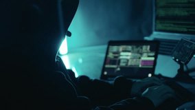 A hacker working on laptop at night. Hacker using computer breaks into government data servers and infects their systems with a virus. Hacker, Cyber security, Cyber crime concept - Powered by Shutterstock - Get 15% off with code: PIKWIZARD15