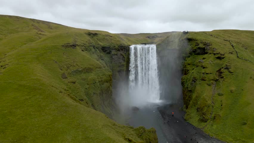 Experience Skógafoss Waterfall from above with our 4K drone footage, highlighting Iceland's epic scenery. Ideal for nature films and travel showcases. Royalty-Free Stock Footage #1111062453