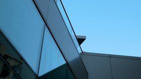 Modern architectural detail with angled glass facade against sky. - Powered by Shutterstock - Get 15% off with code: PIKWIZARD15
