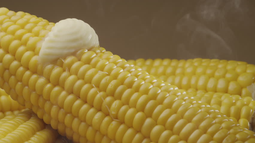Piece of butter is slowly move along the ripe boiled cob of corn. Nice food background for your projects. Macro video shooting.  - Powered by Shutterstock - Get 15% off with code: PIKWIZARD15