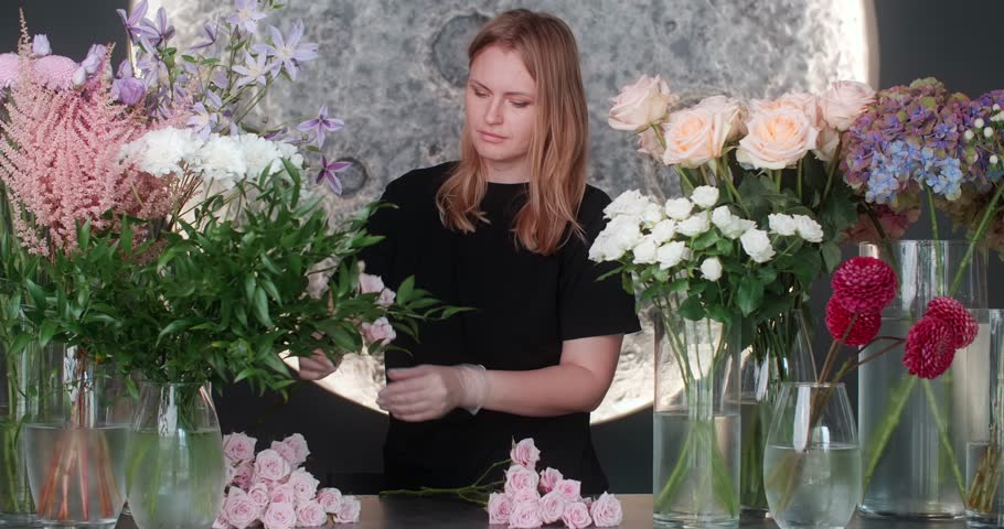 The florist works with flowers in her store | Shutterstock HD Video #1111072129