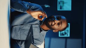 Vertical video African american content creator filming technology review of newly released laptop, unboxing it and presenting specs to audience. Influencer showing ultra slim notebook to viewers - Powered by Shutterstock - Get 15% off with code: PIKWIZARD15