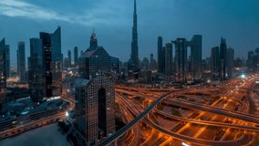 Moody night to day timelapse view of skyline of Downtown Dubai and busy Sheikh Zayed road intersection, United Arab Emirates, with clouds and rain - Powered by Shutterstock - Get 15% off with code: PIKWIZARD15